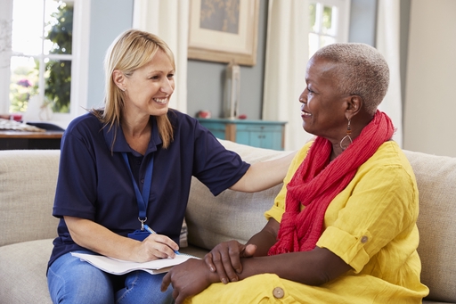 A live-in care consulatant in discussions with a client.