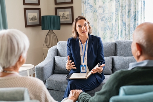 A live-in care adviser discussing live-in care with a couple.
