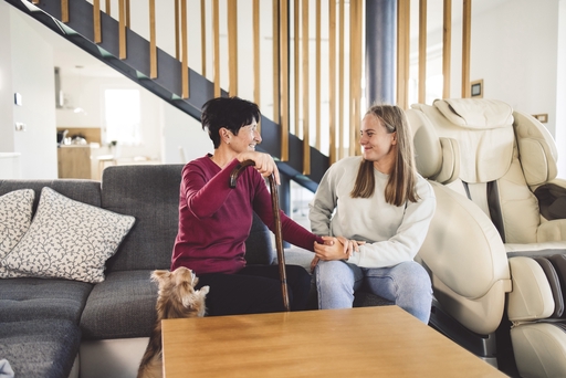A woman sitting down talking to a live-in nurse.