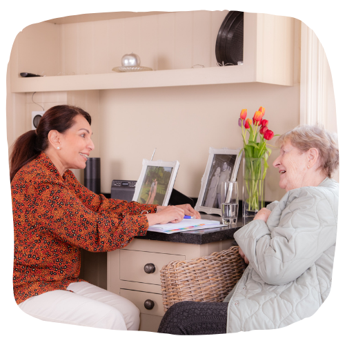 Carer and client smiling and talking