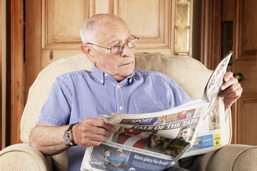 Client reading the newspaper in his armchair