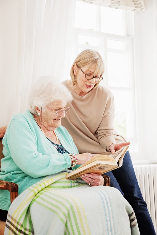 Client and carer looking at a book together