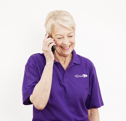 Carer smiling whilst talking on the phone